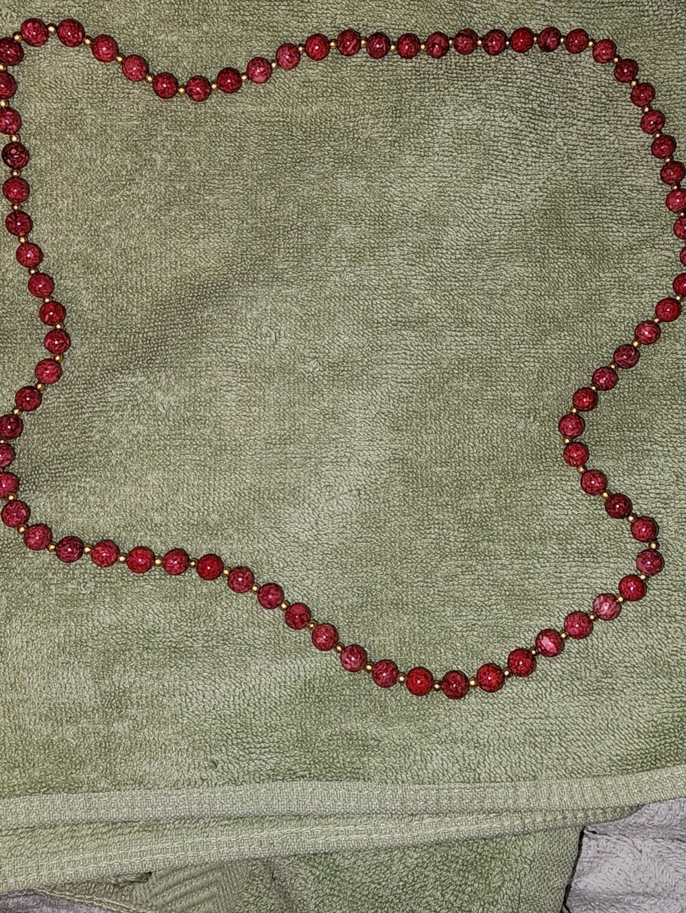 vintage red bead necklace featuring textured red beads separated small gold-tone